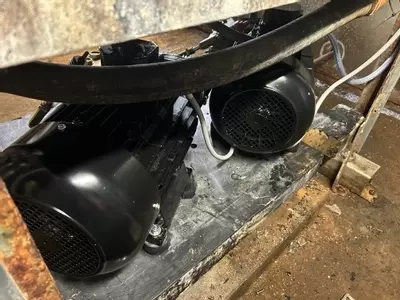 Rear view of Replacement electric motors fitted to multi-pump pressure washer system during repair at a malt house in Burton.